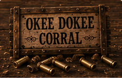 A weathered sign for the Okee Dokee Corral with spent shells in the dirt.
